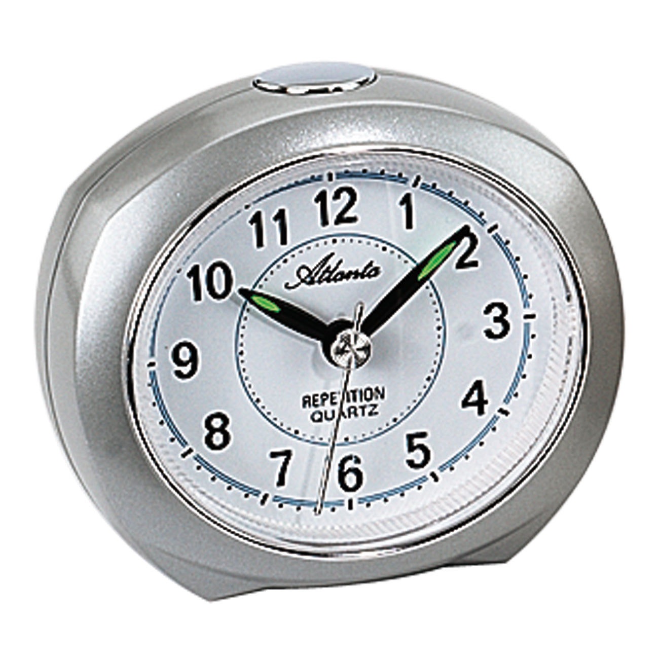 Réveil compact avec boîtier argenté, cadran analogique et aiguilles vertes.