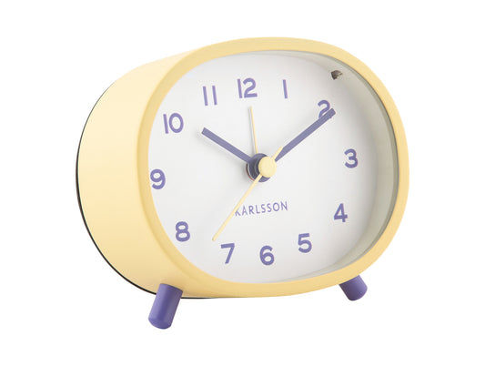 Horloge de table ovale avec cadre jaune, cadran blanc et pieds violets