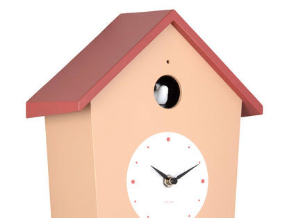 Horloge murale de maisonnette : façade beige, toit rouge, cadran rond et ouverture pour oiseau