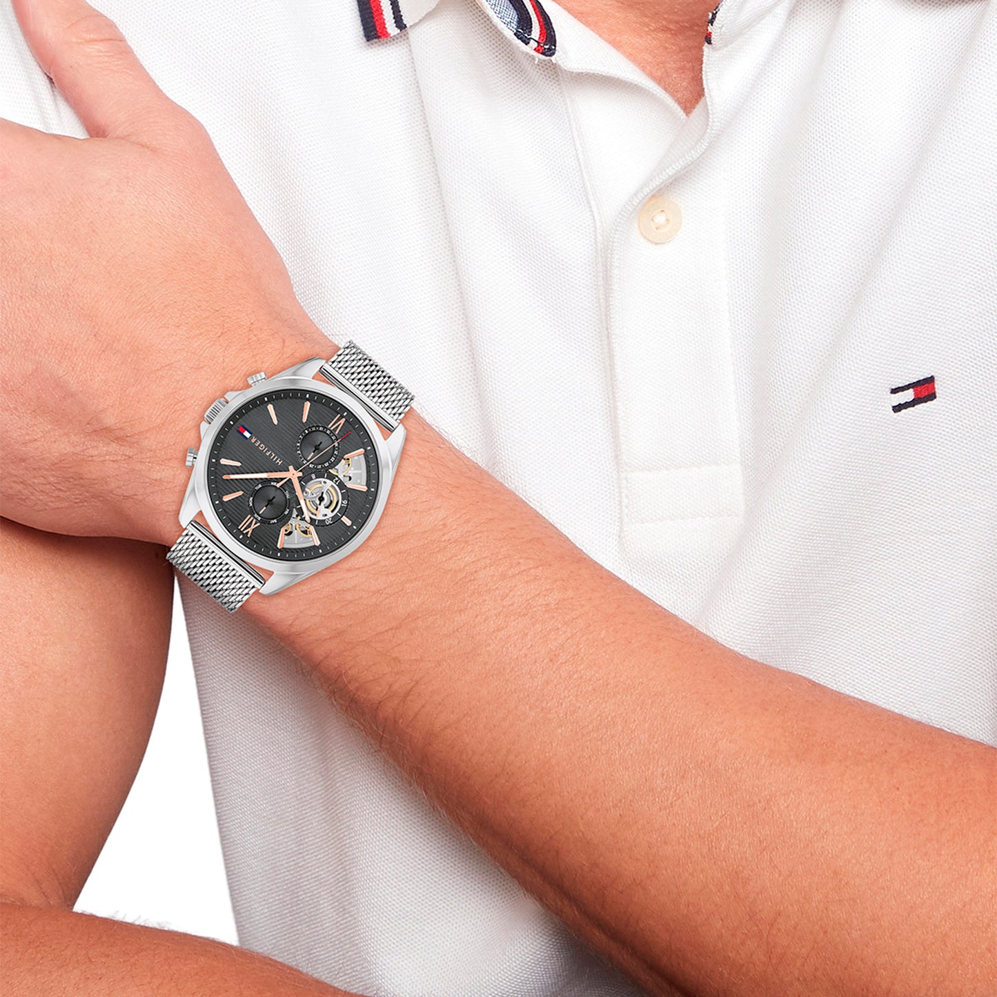 Armbanduhr am Handgelenk: silbernes Metall-Meshband und schwarzes Zifferblatt mit Chrono
