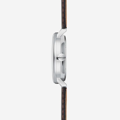 Bracelet montre en profil latéral : boîtier argenté avec bracelet en cuir marron