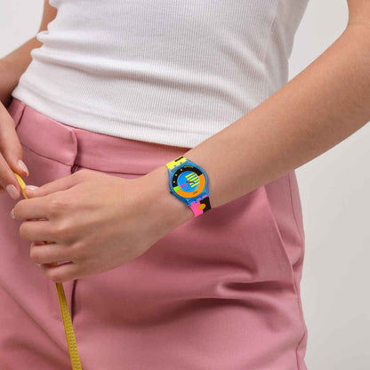 Damenuhr am Handgelenk, blaues Armband mit Neon-Details und buntes Zifferblatt