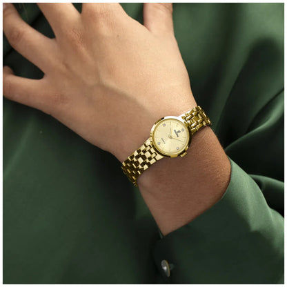 Damenuhr mit goldfarbenem Metallarmband am Handgelenk, rundes Zifferblatt