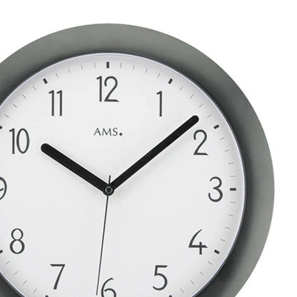 Nahaufnahme Funk-Wanduhr: schwarzes Gehäuse, weißes Ziffernblatt, schwarze Zeiger