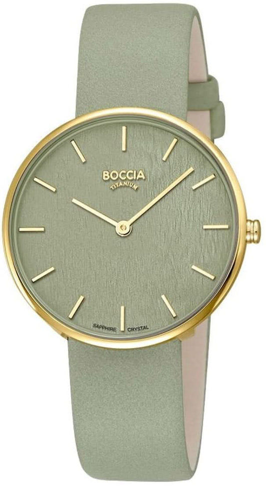 Damklocka med grönt armband, runt guldfärgat boett och beige urtavla
