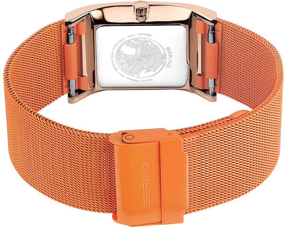 Damklocka med spänne på armbandet, orangefärgat meshband i milanesisk stil med Bering-prägling.