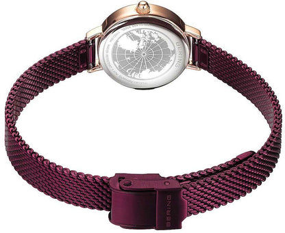 Damklocka med lila metallflätat band, rund boett med gravyr, roséguldigt spänne.