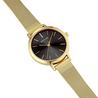 "Damklocka i snedbild: guld färgad rund ram, svart urtavla, Milanese-armband"