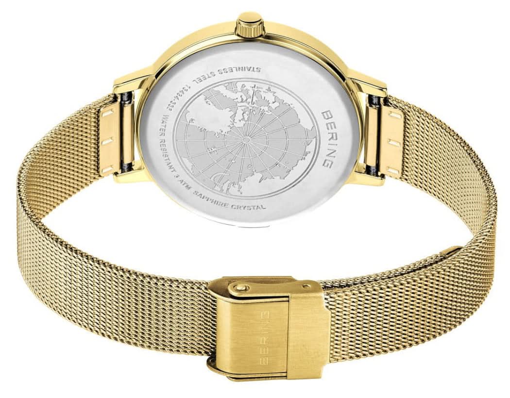 Damklocka, bakvy med graverat boettlock och guldfärgat milanesarmband