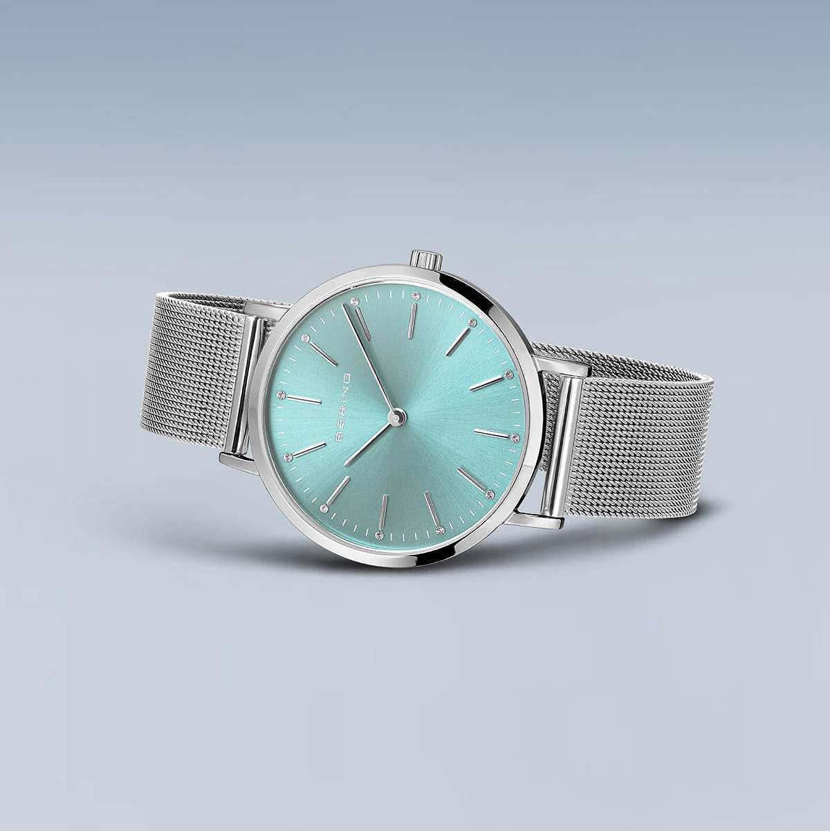"Damklocka med rund turkos urtavla och silverfärgat Milanese-band"