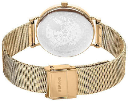 Damklocka med världskartadetalj på baksidan och guldfärgat Milanese-armband