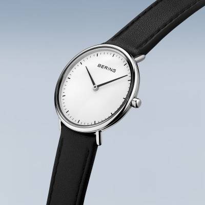 Bering Damenuhr mit schwarzem Lederarmband, silbernem runden Gehäuse und weißem Zifferblatt