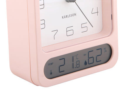 Närbild rosa väckarklocka-display med temperatur- och luftfuktighetsvisning