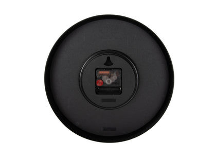 Baksida på väggklocka i mörkgrått med batterifack och synlig mekanik