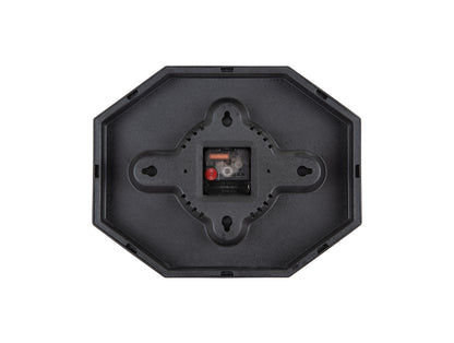 Karlsson klocka baksida med svart åttakantigt hölje och synligt urverk