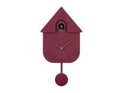 Väggklocka i fågelholksdesign, vinrött hölje med visare, mässingsöppning och runt pendel.