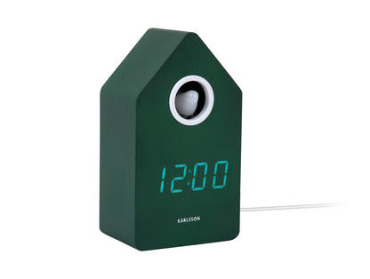 Retro LED-gökur med grönt hus, runt fönster och visning 12:00
