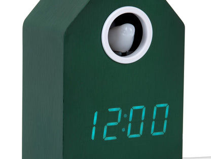 Retro LED-gökur i detalj: grönt hus med runt ljusfönster och visning 12:00