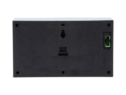 Baksida på bordsklocka: svart hölje med batterifack och display