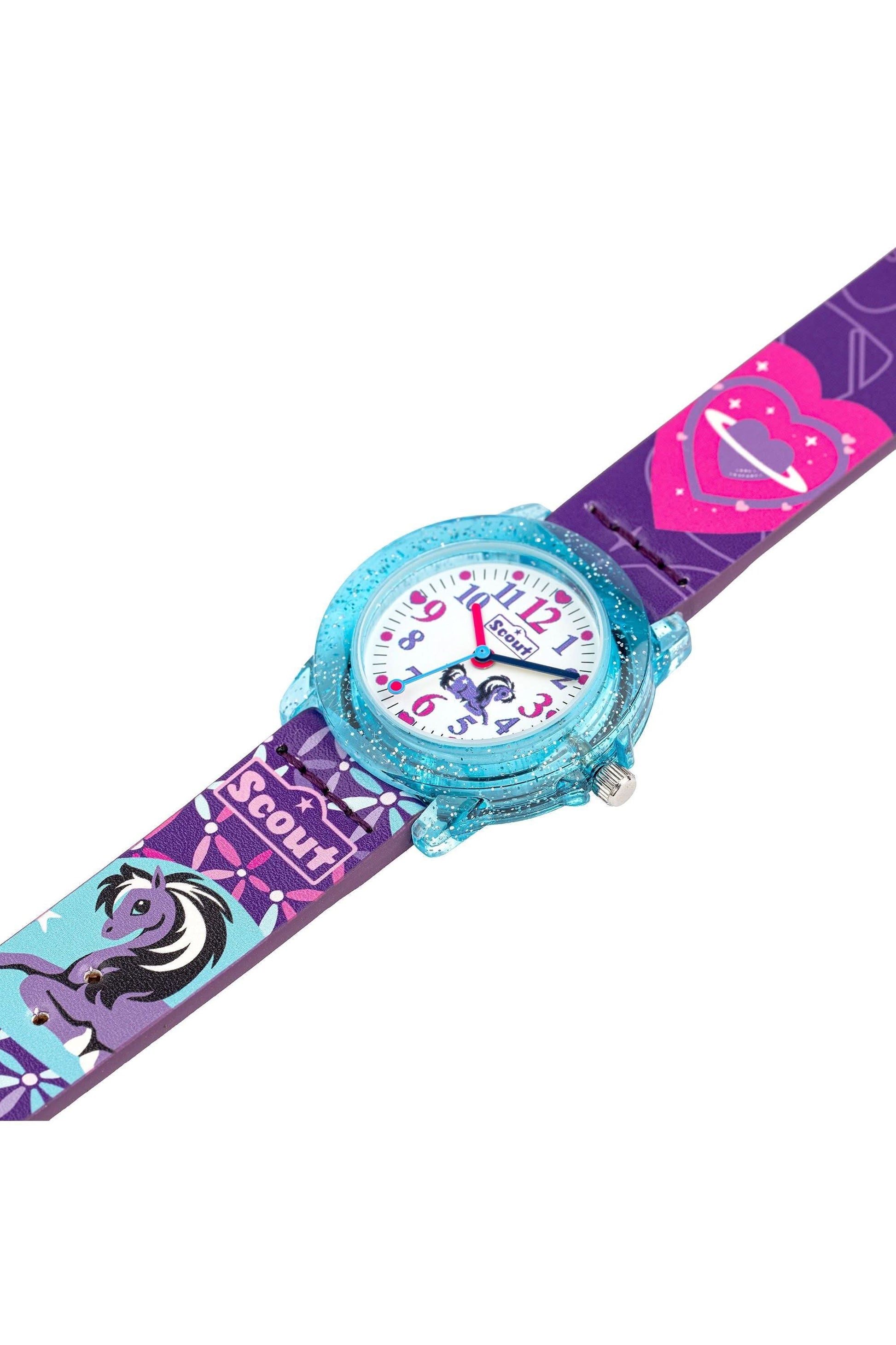 Barnklocka buren snett, lila band med motiv och blått gnistrande boett
