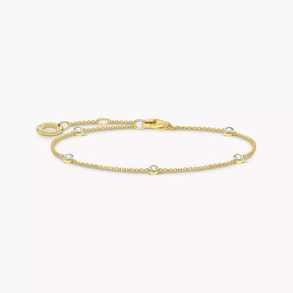 Guldpläterat armband med vita stenar och ovala länkar