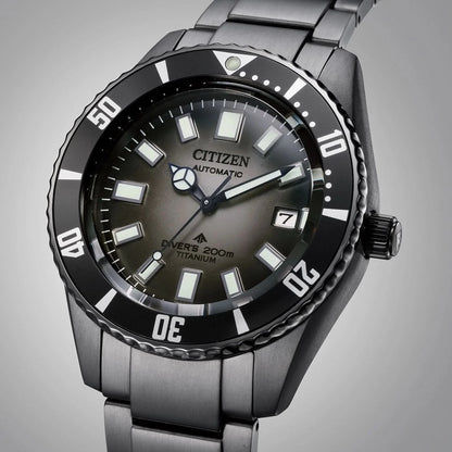 Mörk dykarklocka med svart infattning, självlysande index och metallarmband