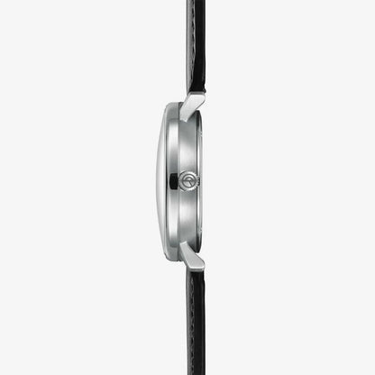 "Herrklocka från sidan: silverfärgat stålhölje, krona och svart läderarmband."