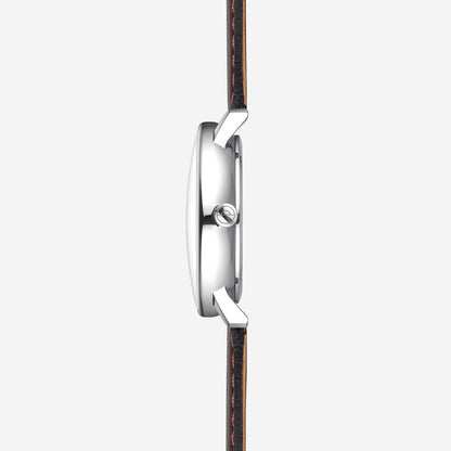 Sternglas herrur från sidan med silverfärgat hölje och brunt läderarmband.