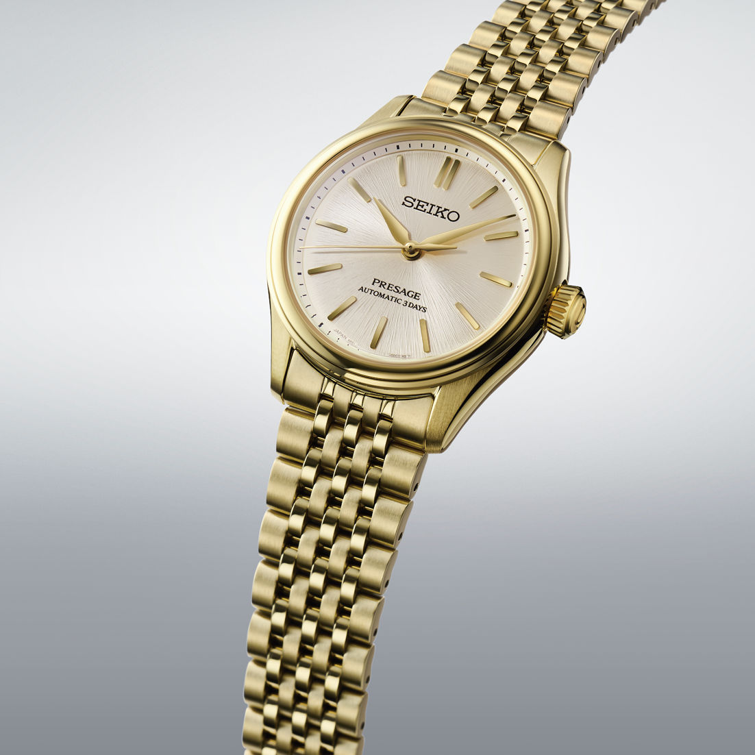 Seiko Presage herrklocka, armband i guldpläterat rostfritt stål, ljus urtavla, sidovy