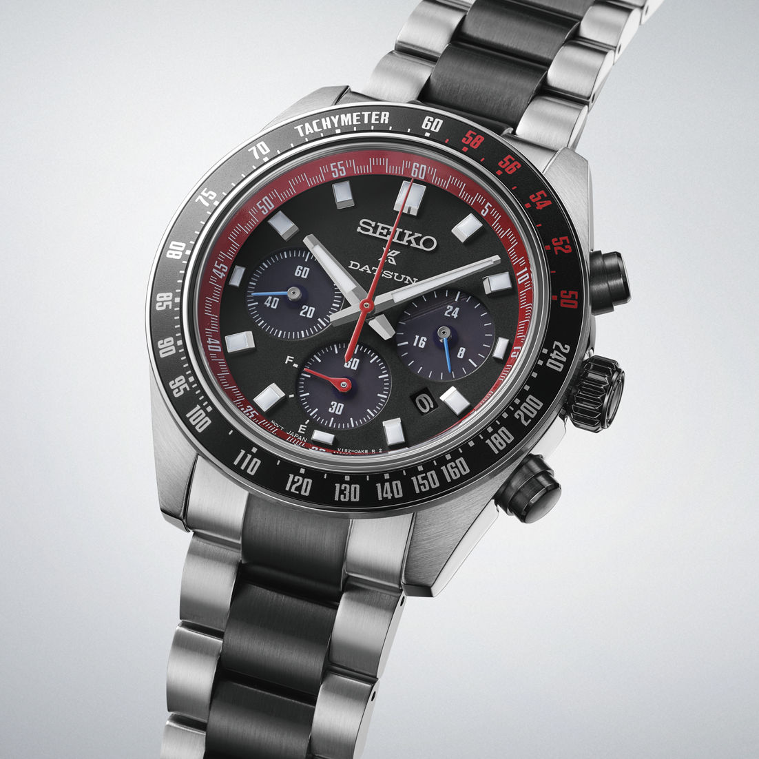 Herrklocka med svart urtavla, röd tachymeter-ring, kronograf, armband i rostfritt stål