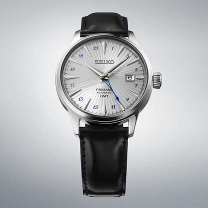 Seiko herrklocka, rund silverfärgad urtavla med datumfönster och svart läderarmband