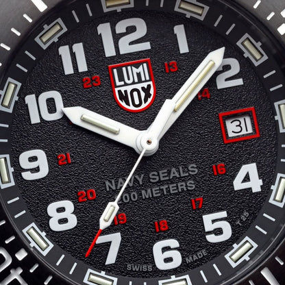 Luminox urtavla med LUMINOX-NOX-logotyp, röda index och datumfönster vid 3
