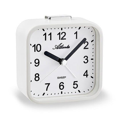 Väckarklocka med vitt hölje, svart urtavla och visare, analog timvisning