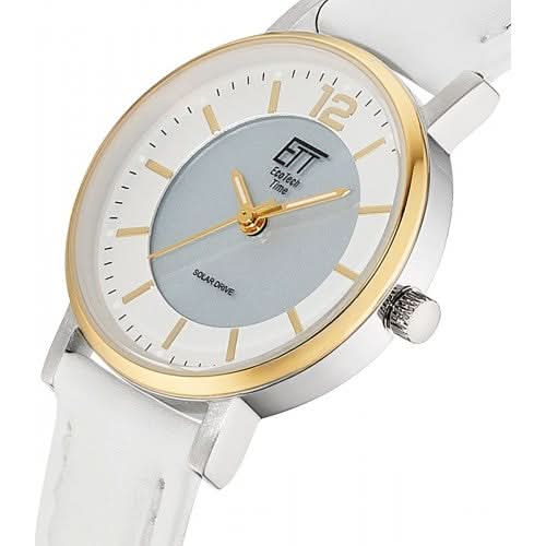 "Damklocka närbild: grå urtavla, guldfärgad infattning, vitt armband"