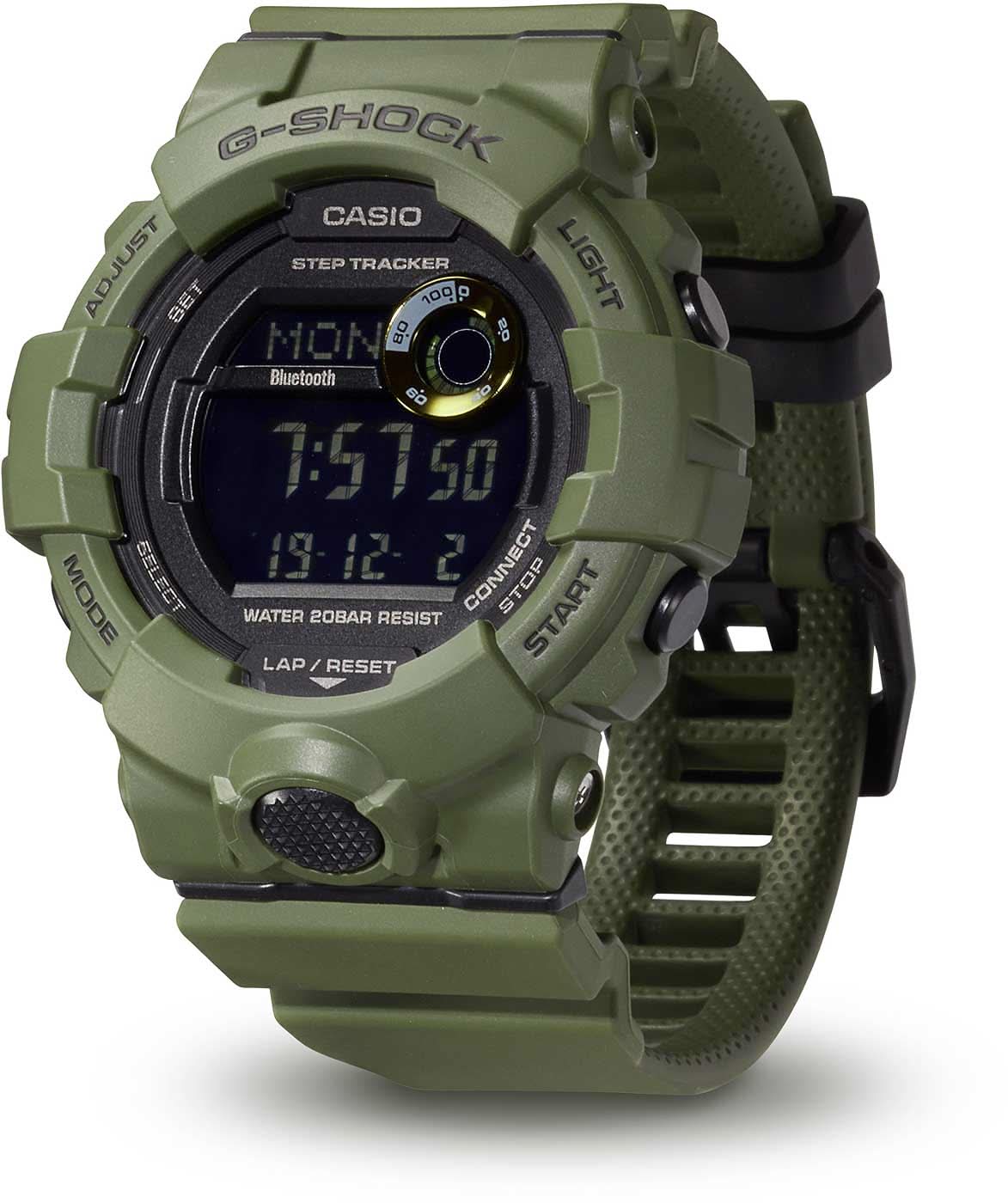 Digital herrklocka med grönt boett, display och G-SHOCK-logotyp