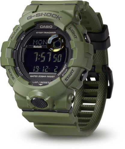 Digital herrklocka med grönt boett, display och G-SHOCK-logotyp