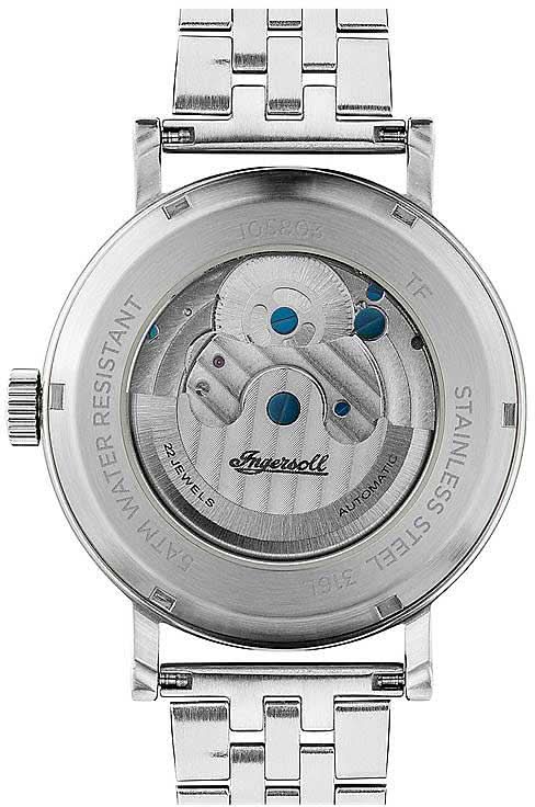 Baksida av herrklocka med glasboett, blå detalj och silverfärgat metallarmband