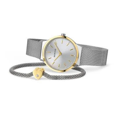 "Damklocka med guldfärgat hölje, silverfärgat milanesarmband och hjärthänge"