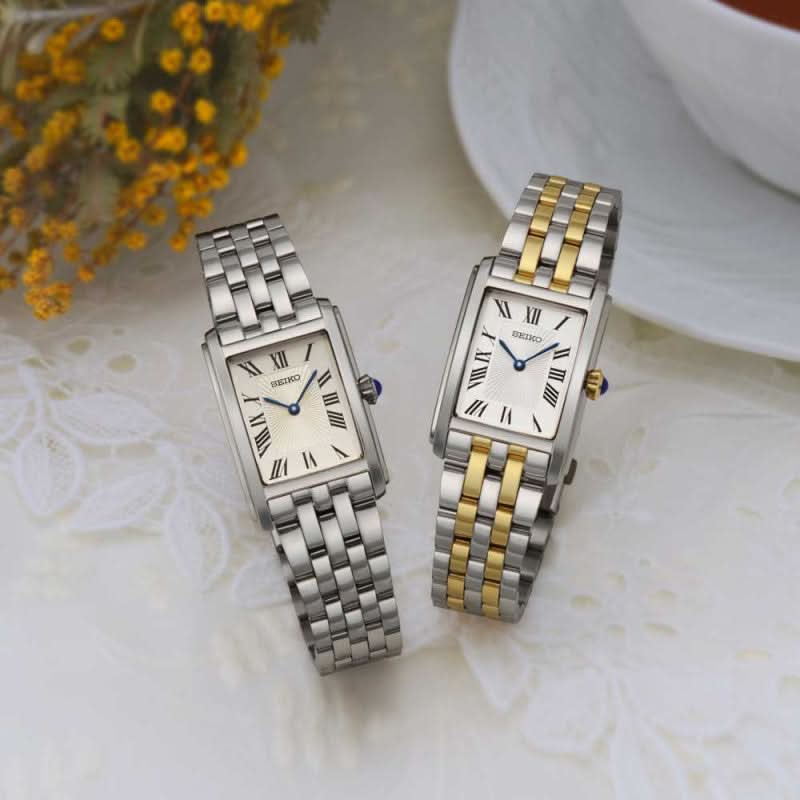 "Två damklockor med metallarmband: silver och tvåfärgad guld/silver, vit urtavla"