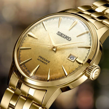 SEIKO herrarmbandsur med guldfärgad urtavla, indexmarkörer, datumfönster vid 6