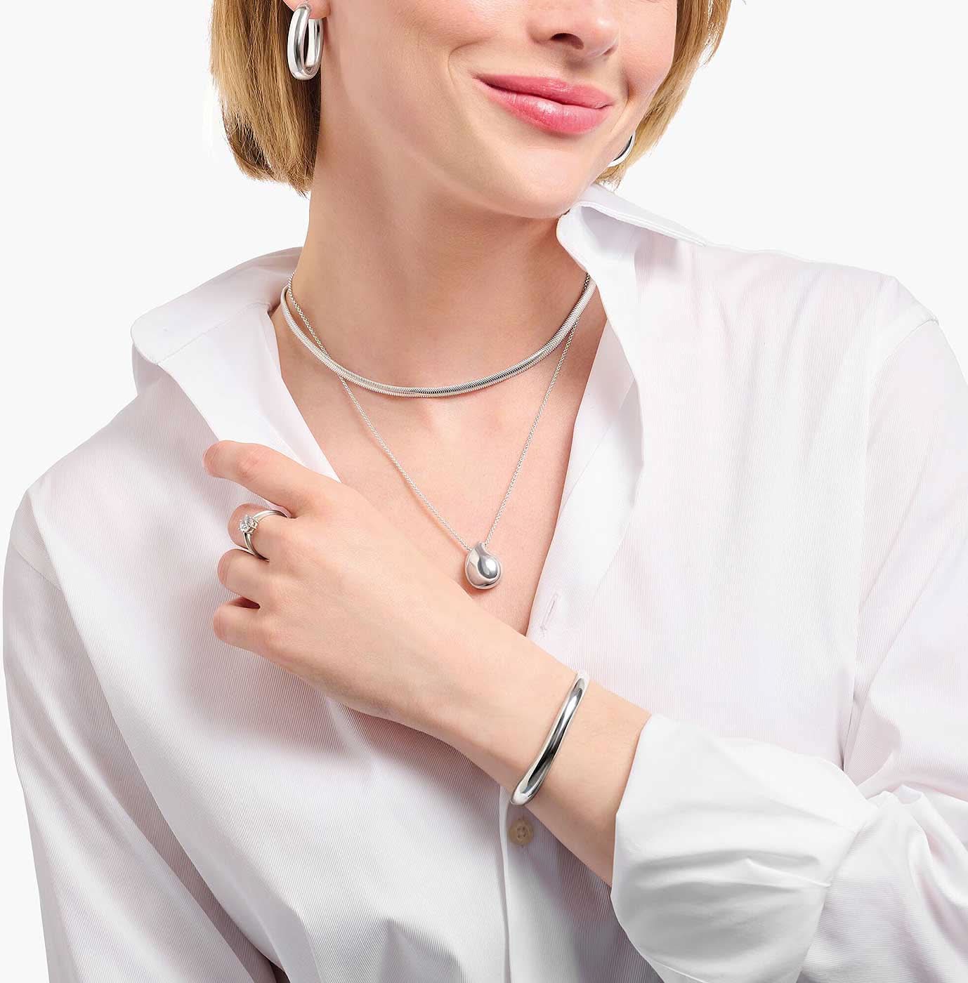 Halsband med silverdroppe runt halsen, buret
