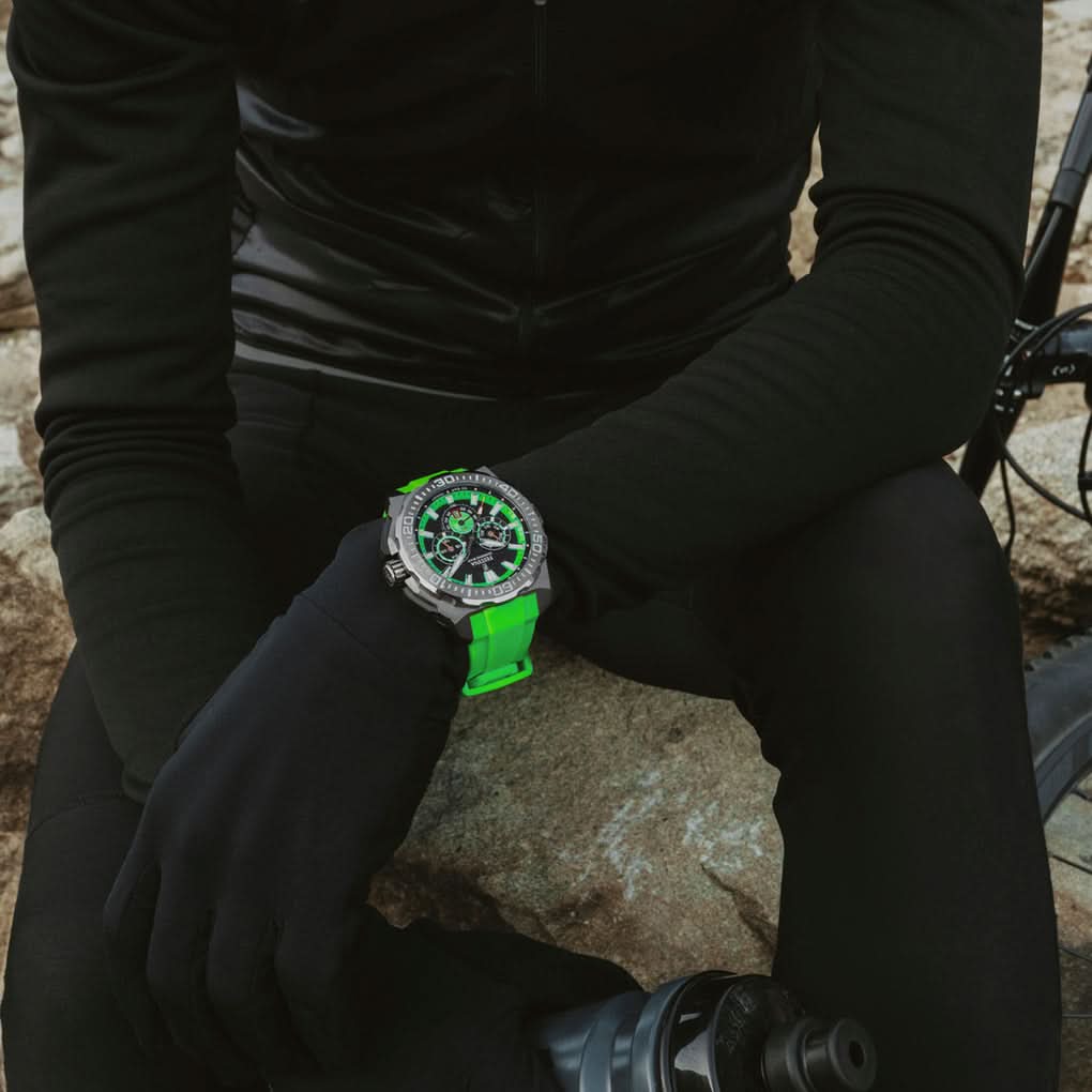 Sportig herrklocka på handleden med grönt silikonarmband och svart urtavla