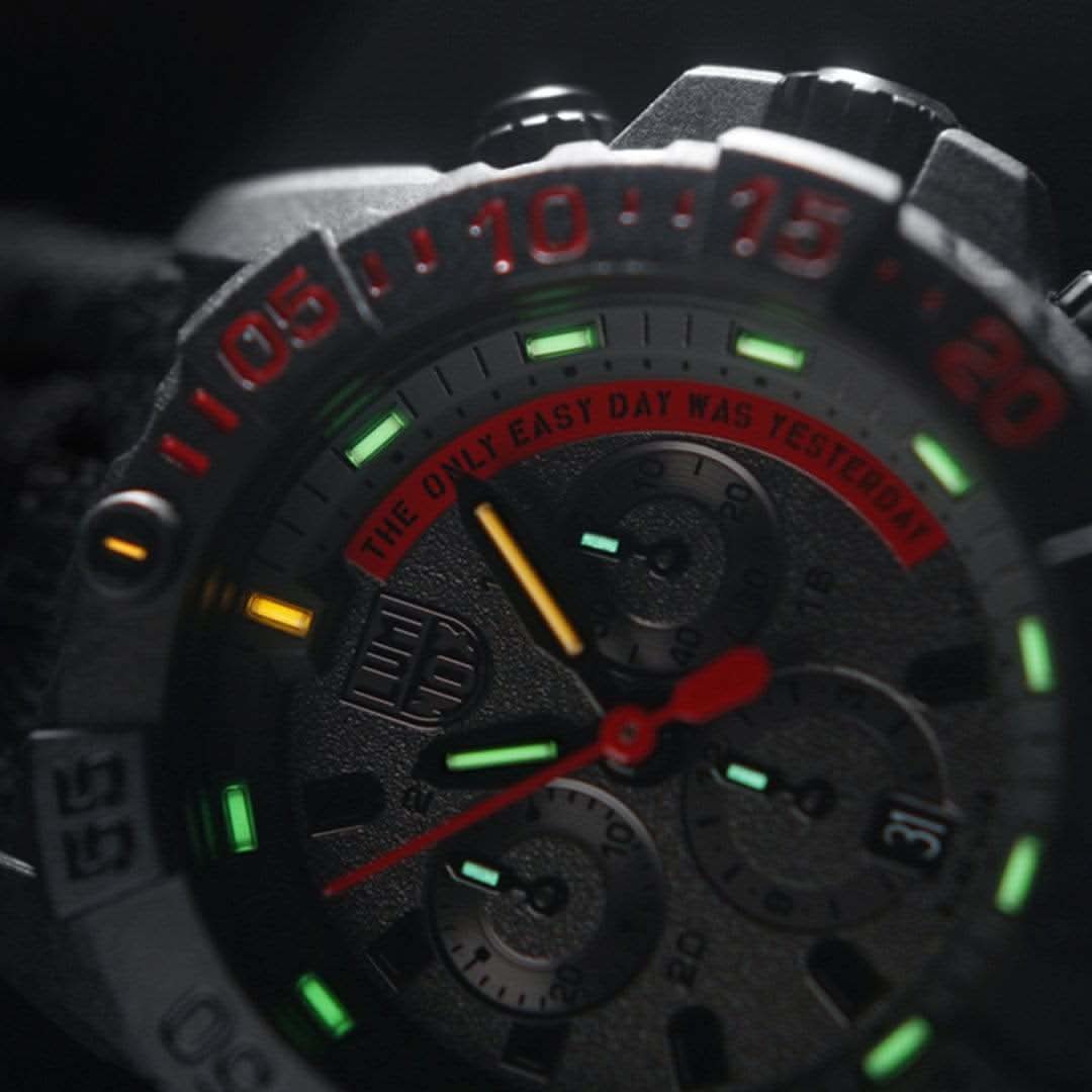 Nahaufnahme der Herrenuhr: rotes Chronograph-Sekundenrad und grüne Leuchtanzeigen