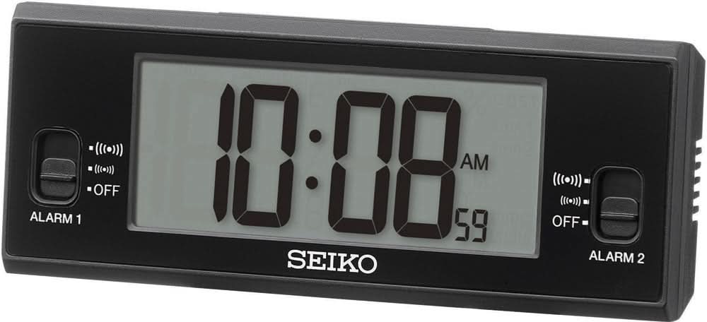 Digital väckarklocka med svart hölje, belyst display 10:18 AM och SEIKO-logotyp