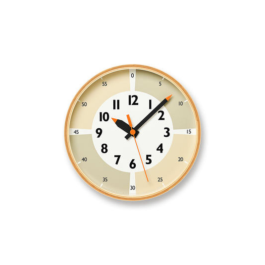 Beige runde Wanduhr mit arabischen Ziffern, schwarzen Zeigern und orangefarbenem Sekundenzeiger.