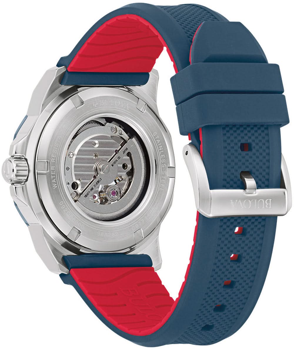 Reloj de hombre con movimiento expuesto, correa azul, detalles rojos en silicona