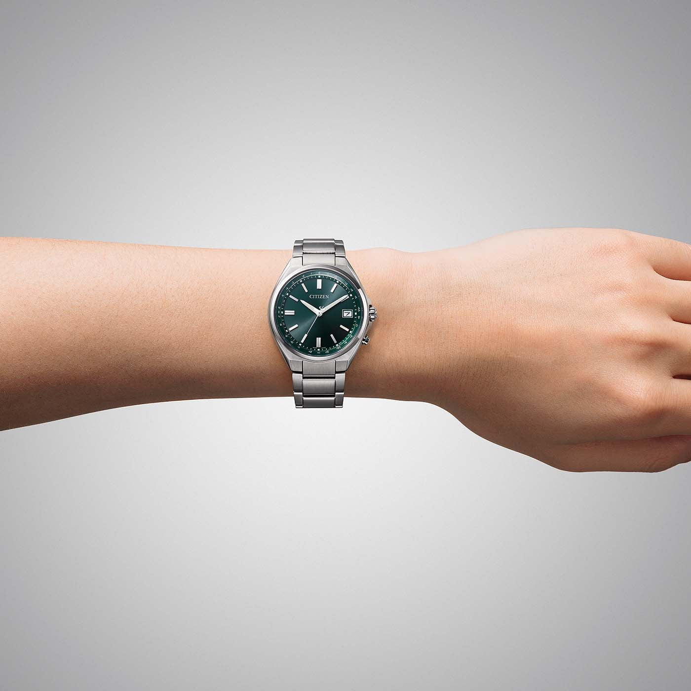 Citizen Super Titanium Armbanduhr am Handgelenk mit grünem Zifferblatt und Edelstahlband