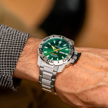 Reloj de buceo en la muñeca con esfera verde y correa de acero inoxidable