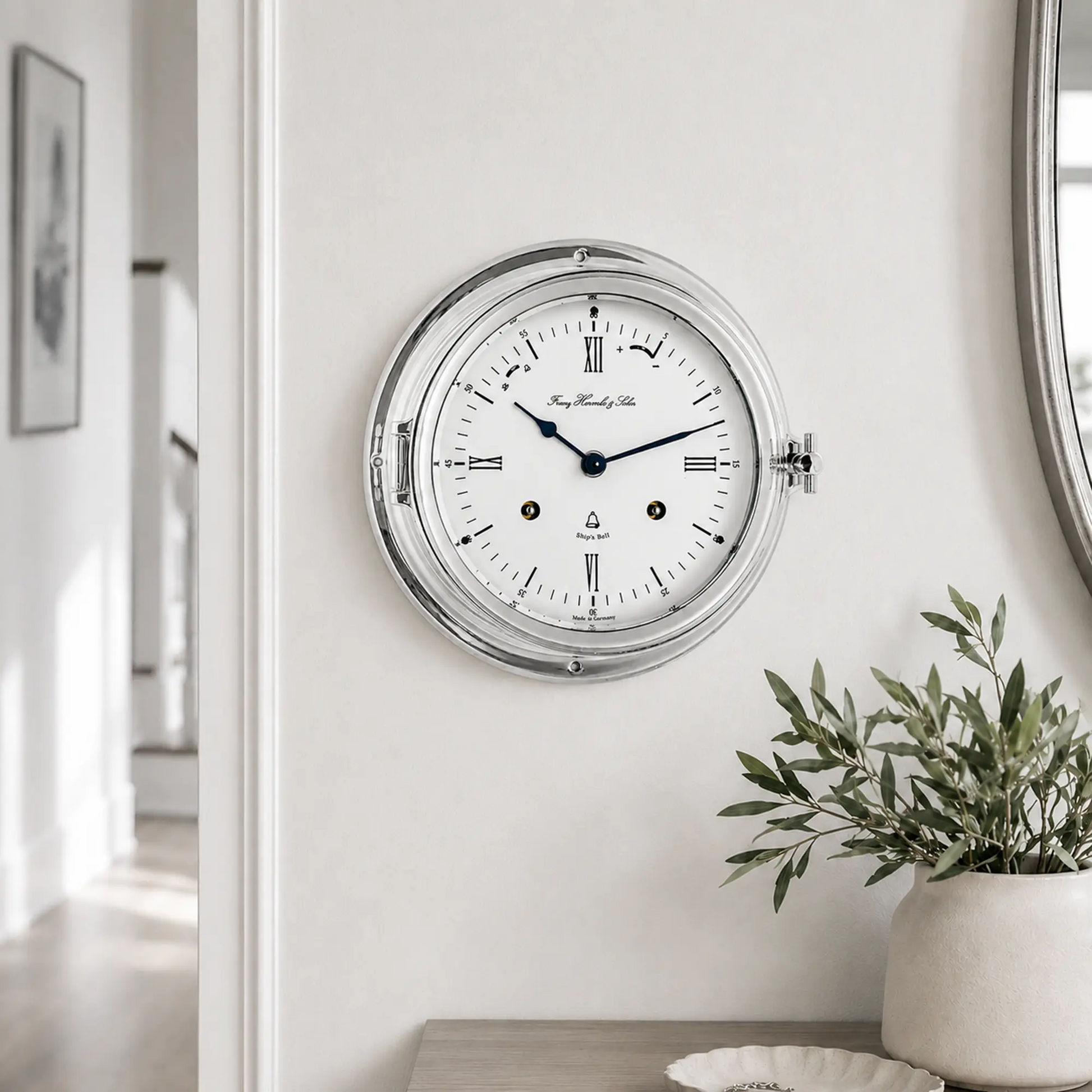 "Reloj de mesa analógico redondo con caja plateada y esfera blanca, manecillas azules"