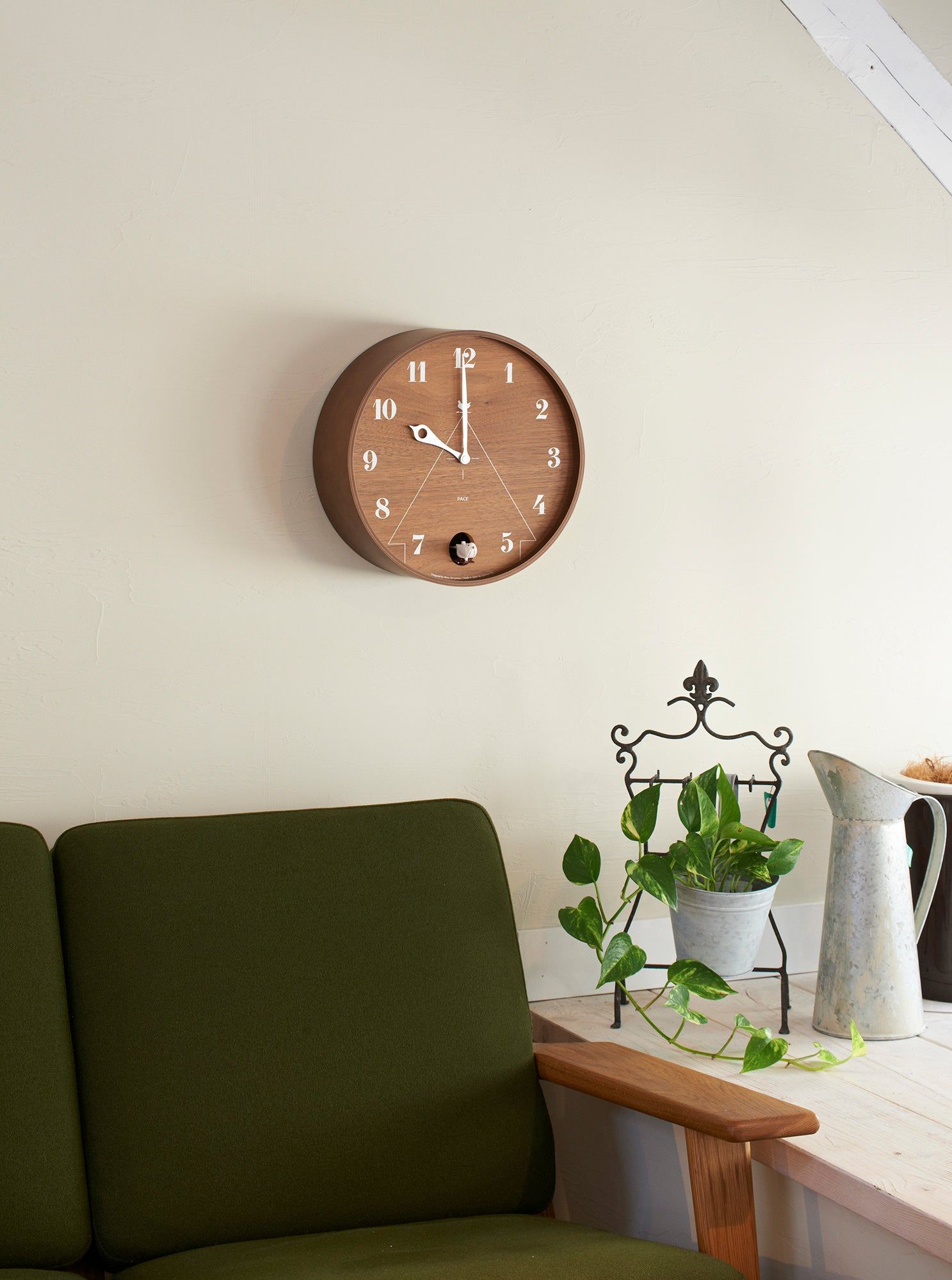 Wandmontierte runde Wanduhr mit braunem Zifferblatt, weißen Ziffern und Zeigern